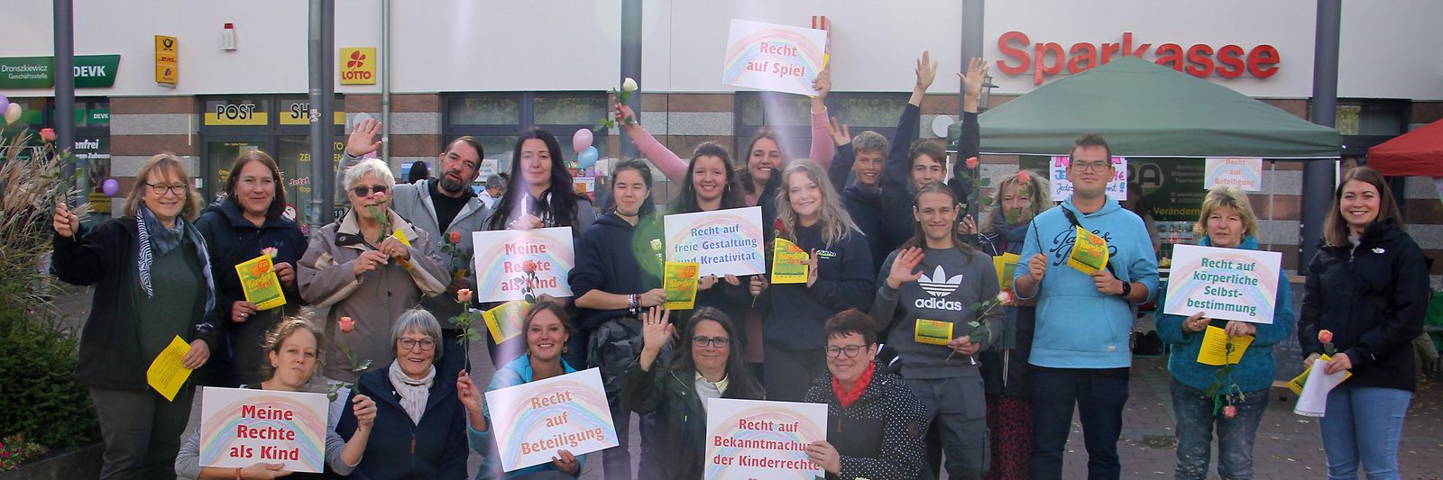 eine Gruppe engagierter Nuthetaler und Nuthetalerinnen, die zum Kinderrechtefest Plakate mit Kinderrechten hochhalten