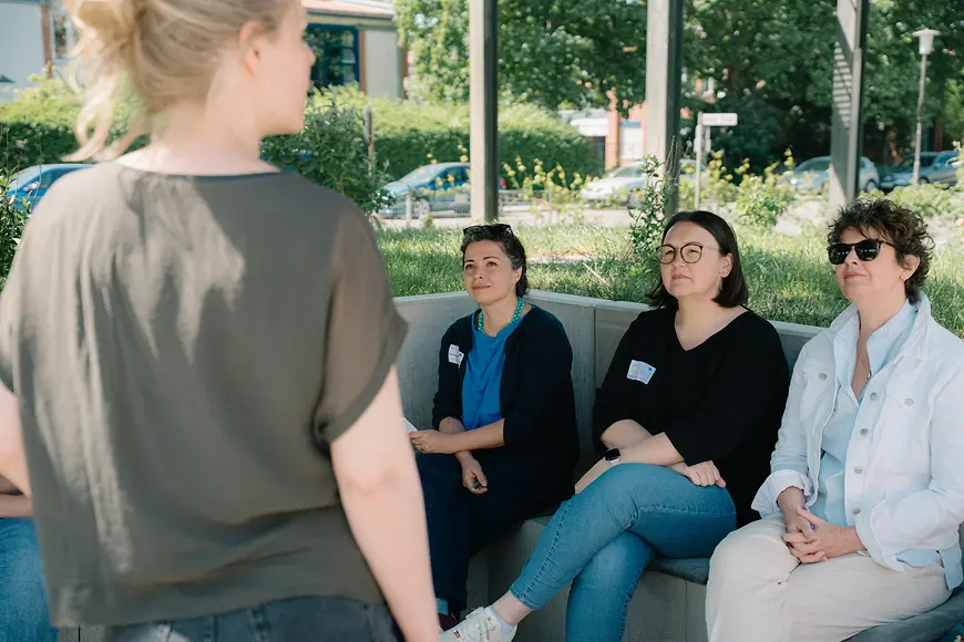 3 Frauen hören bei einem Workshop zu